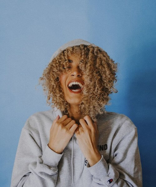 woman with mouth open looking joyful