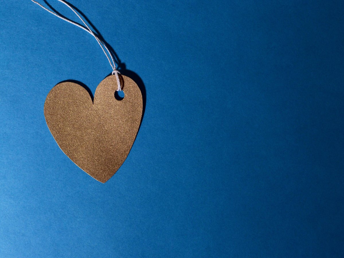 Cardboard heart tag on blue background symbolizing attachment-based relationship therapy in Los Angeles