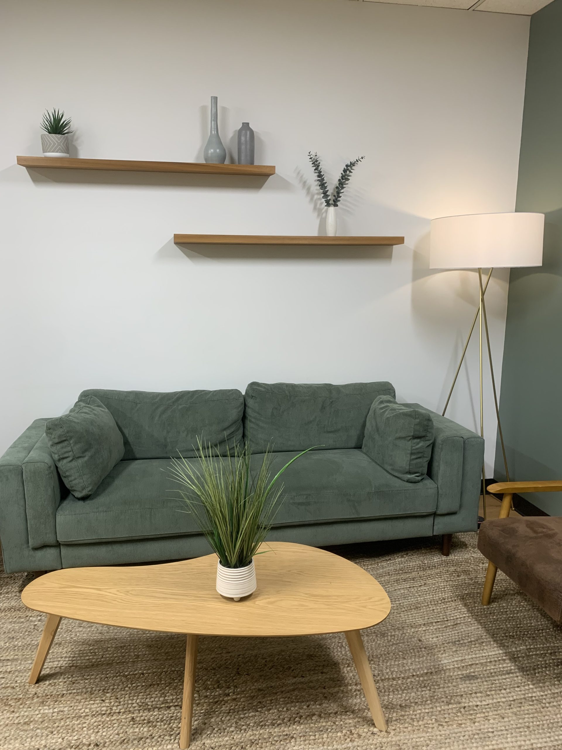Calming therapy office with green couch used for attachment-based therapy sessions in Encino, Los Angeles
