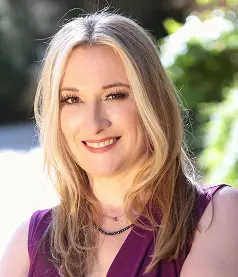 Kirstin Carl with long blonde hair wearing a purple top
