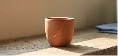 A small pot placed on a wooden table